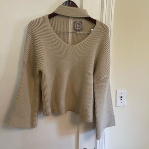 Womens cutout sweater with flare sleeves.